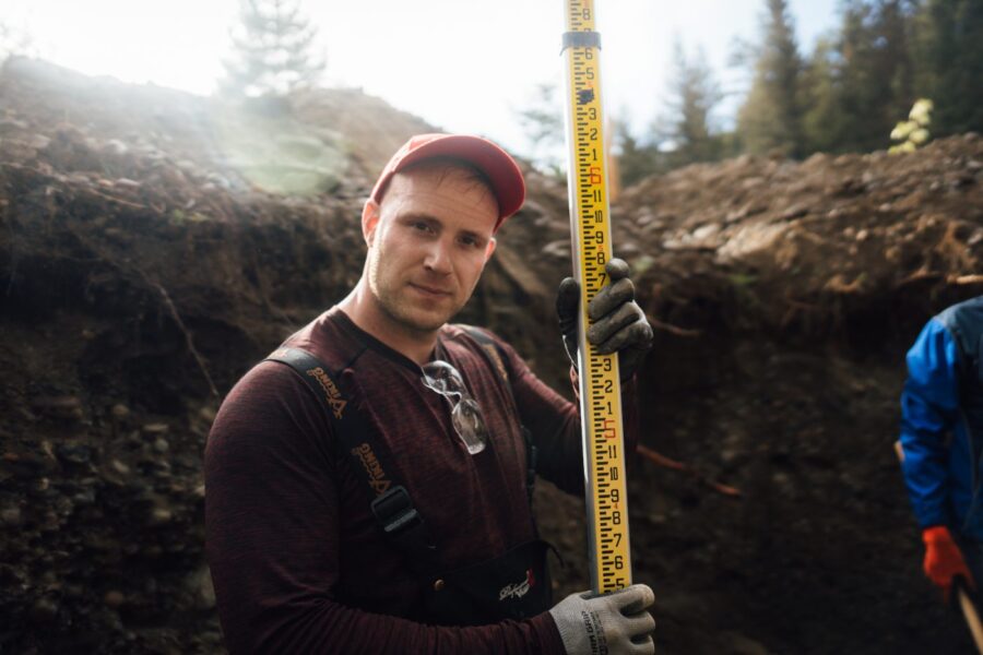 Proseptix ROWP practitioner measuring a soil test pit with a grade rod