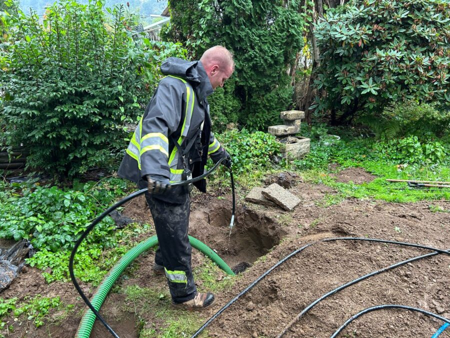 Proseptix technician with hoses at an excavated septic line