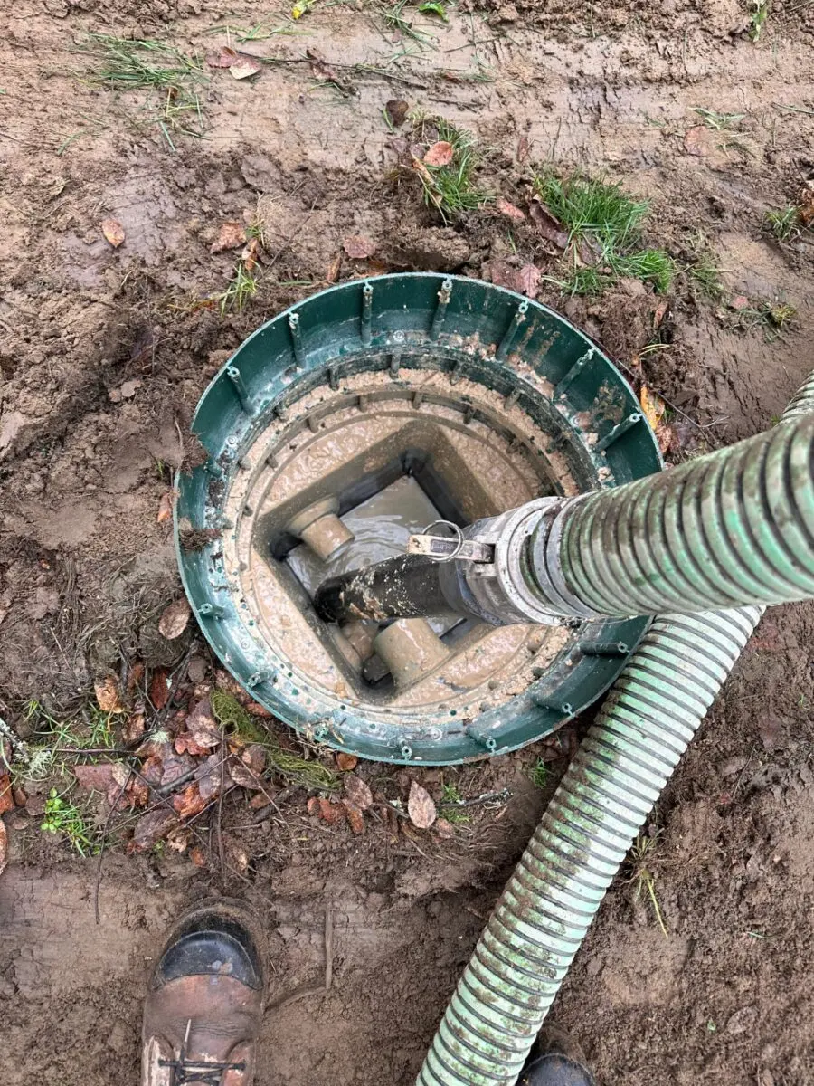 Hose in a septic tank riser during service by Proseptix